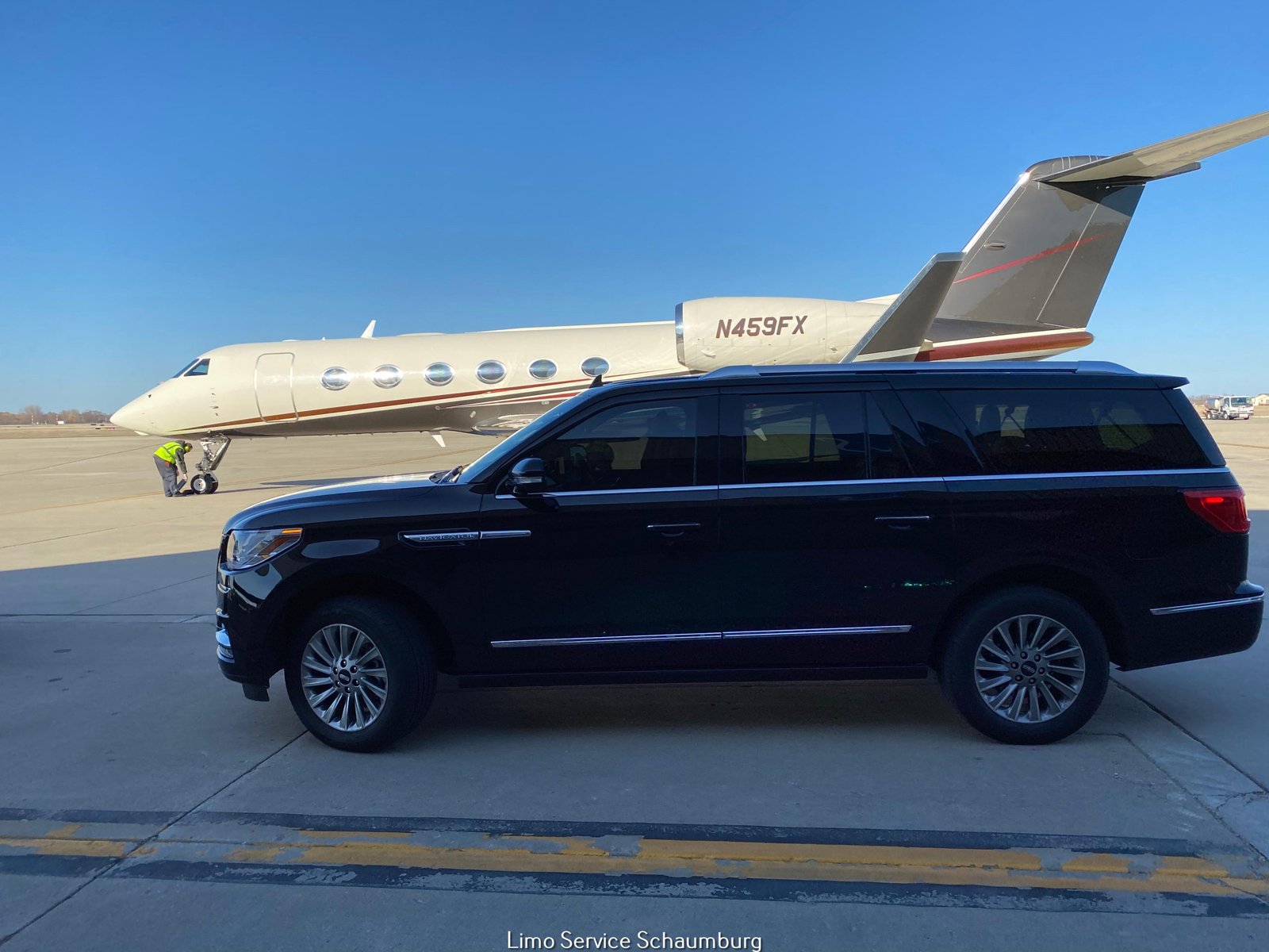 Skyline Chicago - Luxury SUV parked near private jet on tarmac.