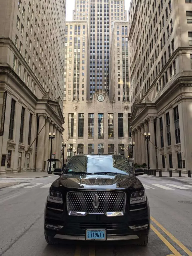 Luxury car in front of Chicago Board of Trade building