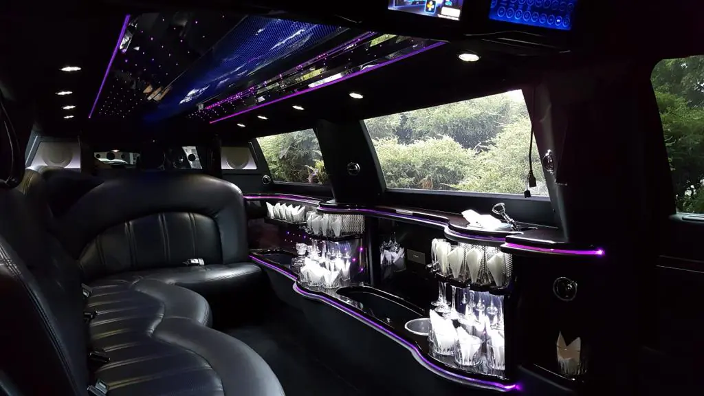 Luxurious limousine interior with mood lighting and bar