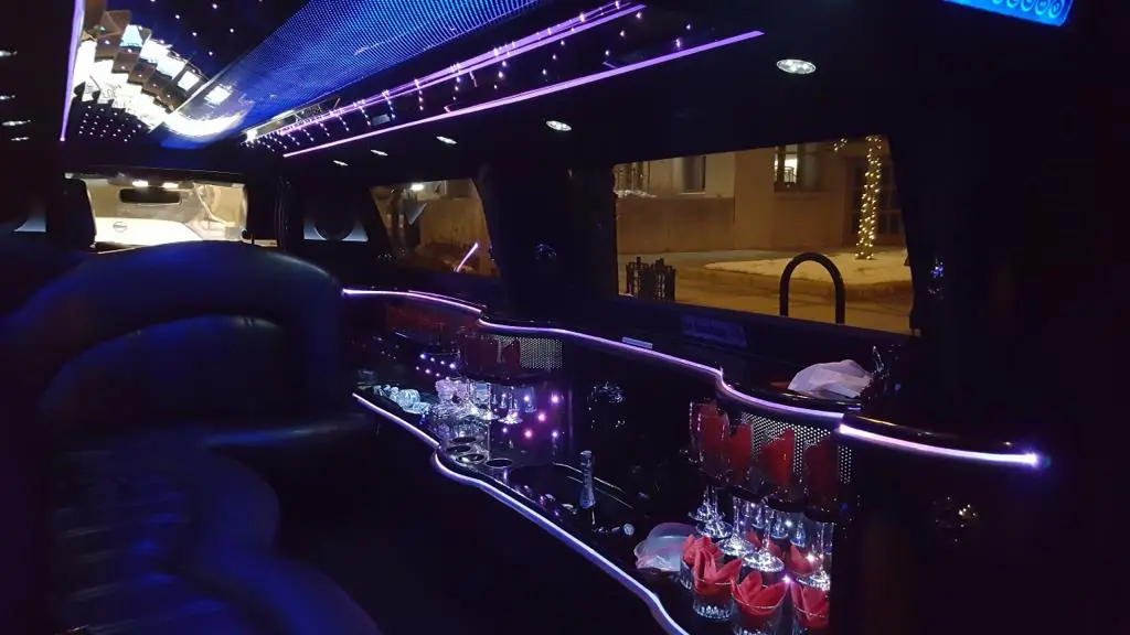 Luxurious limousine interior with neon lights at night