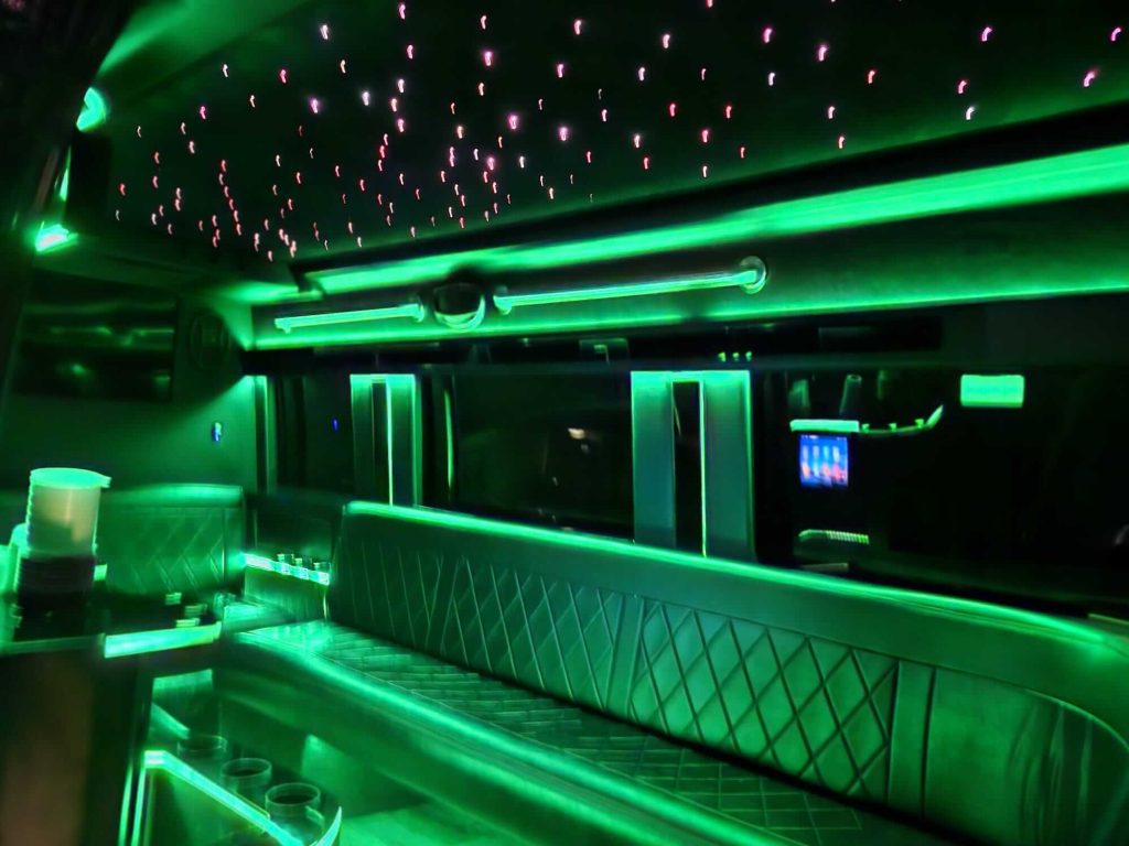 Green-lit limousine interior with neon ceiling lights