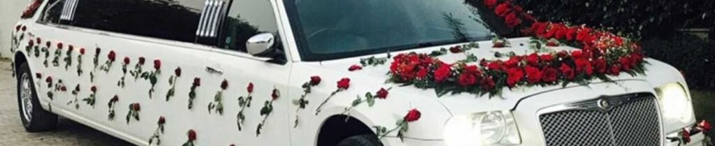 Are Limos Only for Special Occasions? - White limousine decorated with red roses.