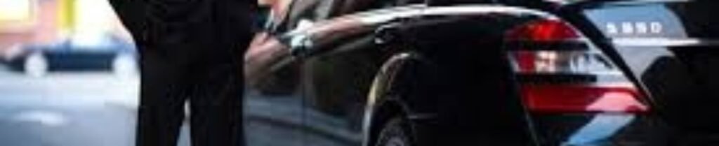 Airport Car Service Work - Chauffeur opening luxury black car door on street.