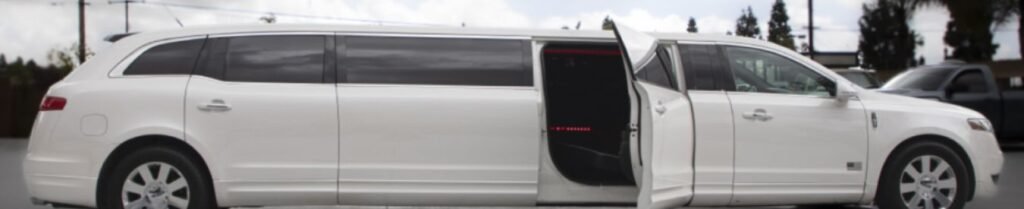 How Early Do Limousines Arrive for Pickup? - White stretch limo with open door in parking lot.