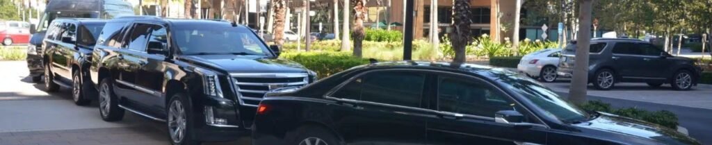 How Far in Advance Should I Book a Limo? - Three black luxury cars parked on urban street.