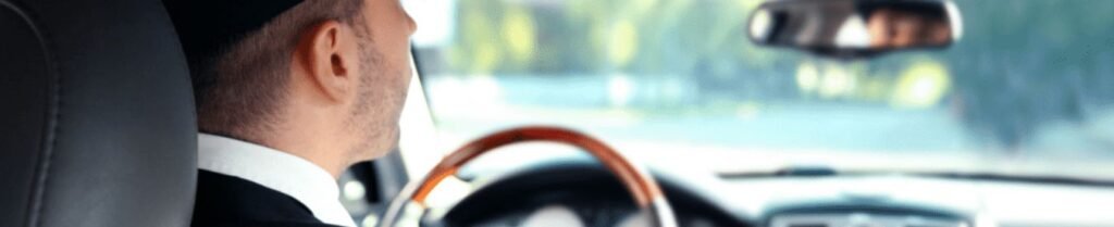 How to Become a Chauffeur - Driver in car, rear view mirror focus.