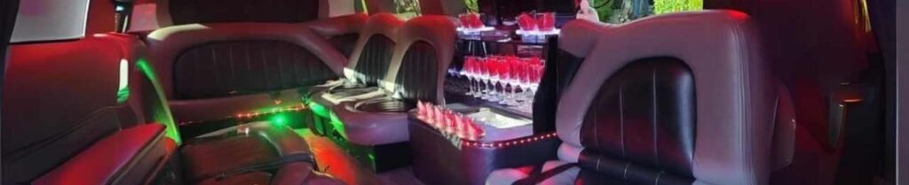 Is a Limo Service Better than Uber? - Luxury limousine interior with colorful lighting, glasses.