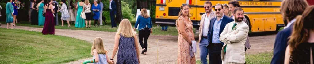 Should I Provide Transportation for Wedding Guests? - Group of people outdoors by school bus
