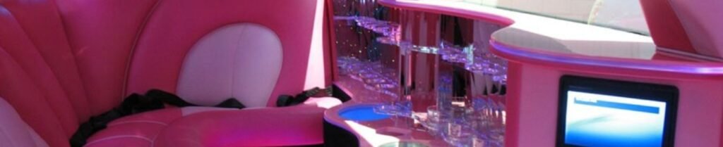 Should I Rent a Limo for My Birthday Party? - Pink limousine interior with bar and screen.