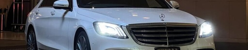Hourly and Flat Rate Limo Services - White Mercedes-Benz parked under dim lighting