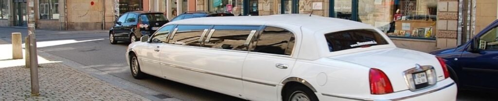 What Questions Should I Ask a Limo Company Before Booking? - White limousine parked on a city street.