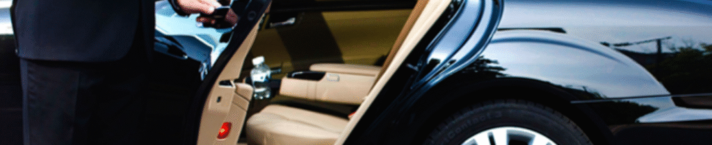 Private car service - Chauffeur opening luxury car door