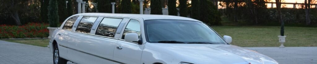 What is the Typical Cancellation Policy for Limo Services? - White limousine parked on a paved driveway.
