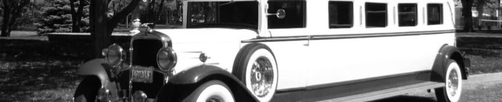 Who Invented the Limousine? - Vintage limousine parked in a shaded area.