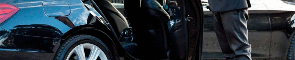 Hire a chauffeur - Chauffeur opening luxury car door for passenger